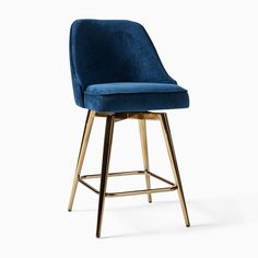 an upholstered blue velvet bar stool with gold metal frame and footrests