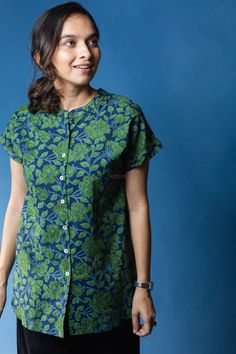 Inspired by the soul-stirring calmness of the woods, Kaira features exquisite hand block printed leafy motifs. The emerald green of the print is contrasted beautifully with the blue of the shirt. Tailored out of 100% premium cotton, Kaira has an elegant round collar and 3/4th sleeves. Casual or formal, Kaira can be styled effortlessly. Contrast Sleeves Kurti, Printed Cotton Tops For Jeans, Chicken Dress, Cotton Tops Designs, Green Parrot, Cotton Short Dresses, Simple Kurta Designs, Designer Kurti Patterns, Kurti Patterns