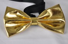 Mens PVC Faux Leather SOLID Gold Golden  Shining Bow Tie Bowties Wedding Party Item               PVC Faux Leather Gold Shining Bow Tie Condition      Brand New Color       GOLD Size               L 11.5cm*W 6cm*H1.5cm Material       Faux Leather Package       1  Gold Color  Background Leather Bow Tie Due to the use of flash photography, there may be slight or no color variation of item described   Payment Payments options: ETSY PAYMENT   Shipping Product will be shipped within 24 Hours of receiving cleared payment. You will receive our confirmation email 3 to 6 working days in Australia If you bought on Friday, the item may be delivered longer than usual, since the following 2 days (Saturday and Sunday)are not working days. Once you buy the item near the Public holiday, such as Christmas Fitted Gold Bow Tie For Wedding, Elegant Gold Bow Tie For Party, Adjustable Gold Bow Tie For Party, Gold Color Background, Gold Bow Tie, Leather Bow Tie, Leather Bow, Flash Photography, Color Background