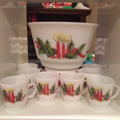 a set of christmas themed dishes and cups