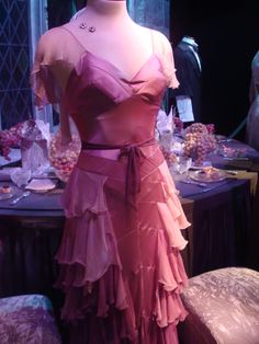 a mannequin dressed in a pink dress with ruffles on the skirt