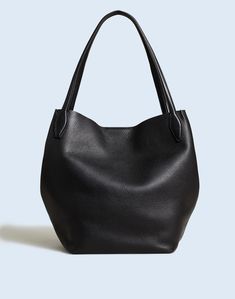 Perfectly luxe, our soft grain leather is tumbled for 48 hours to bring out the natural pebbling and then hand cut into the ultimate oversized shopper tote. Crafted with artisan details, it has collapsible sides that close with a dog clip that doubles as a key fob. It's spacious enough to hold your gym clothes, a large water bottle, phone, wallet and more—plus, it has shoulder straps.Leather.Magnetic closure.Interior pocket.9 1/2" handle drop.12 3/4"H x 12 3/4"W x 7 1/2"D.Imported. Madewell Tote, French Capsule Wardrobe, Capsule Wardrobe Casual, Classic Capsule Wardrobe, Madewell Bags, Dog Clip, Brown Leather Totes, Woven Tote Bag, Fall Capsule Wardrobe