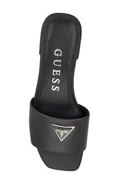 Gleaming logo hardware adds a signature touch to the vamp of a versatile slide sandal fashioned with a square toe for modern appeal. Synthetic and textile upper and lining/synthetic sole Imported Black Slides With Logo, Black Logo Slides, Black Slides With Logo For Summer, Modern Black Slide Mules, Black Logo Slides For Summer, Casual Slide Sandals With Logo, Trendy Slides With Cushioned Footbed And Open Heel, Casual Open Toe Logo Slides, Black Logo Sandals For Summer