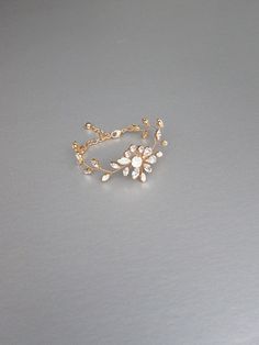 "This delicate floral bracelet is made with beautiful opal and clear Swarovski crystals. The bracelet measures 3/4\" wide in the center and it will fit 6\" to 8\" wrist. Available in gold or silver finish. - For the matching earrings please take a look here: https://www.etsy.com/listing/573107946/opal-bridal-crystal-earrings-swarovski?ref=shop_home_active_1 - For the matching headpieces please take a look here: https://www.etsy.com/listing/595318080/swarovski-crystal-bridal-hair-vine?ref=shop_ho Adjustable Gold Bracelet With Cubic Zirconia For Wedding, Adjustable Gold Crystal Wedding Bracelet, Adjustable Gold Crystal Bracelet For Wedding, Delicate Gold Bracelets For Wedding, Rose Gold Cubic Zirconia Bracelet For Weddings, Dainty White Crystal Bracelet For Wedding, Rose Gold Cubic Zirconia Wedding Bracelet, Wedding Rose Gold Bracelet With Cubic Zirconia, Dainty White Crystal Wedding Bracelet