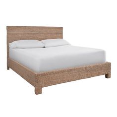 the bed is made with wicker and white sheets