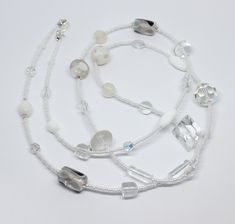 Beautiful and unique white  glass beads necklace. The necklace is made from white and clear glass and crystal beads in different shapes and sizes, making it a truly original piece. The necklace measures approximately 37.5" in length.  Please note that the beads may differ from the one pictured as each necklace is unique. Perfect gift idea or treat for yourself. Wrapped in tissue paper and presented in an organza pouch. White Single Strand Crystal Jewelry, White Crystal Beaded Chain Necklace, White Crystal Jewelry With Beaded Chain, Adjustable White Necklace With Gemstone Beads, Adjustable White Beaded Necklace With Gemstones, Adjustable White Gemstone Bead Necklaces, Adjustable White Gemstone Beaded Necklace, White Adjustable Crystal Necklaces With Round Beads, White Crystal Jewelry With Faceted Beads