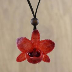 Local Thai artisans carefully select a natural orchid flower ensuring its quality. The beautiful flower is preserved through a painstaking electroplating process which coats it in shining resin to display its dyed ruby hues. Adorning the neck on a length of espresso leather cord this pendant necklace features an adjustable length with sliding glass beads at the clasp. Orchid Necklace, Dope Jewelry, Funky Jewelry, Jewelry Lookbook, Orchid Flower, Dream Jewelry, Jewelry Inspo, Jewelry Packaging, Beautiful Flower