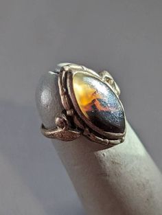 "Antique Arts & Crafts Agate Ring Antique picture Agate ring bezel set in Sterling Silver.  Ring is a size 3 and could be resized by any good jeweler. Face of ring measures 3/4\" running north to south on finger. This is an authentic piece of antique jewelry and ring will arrive gift boxed.   * MARKS Unmarked, tested positive for silver content. * WEIGHT 2.03 Grams. * CONDITION In very good to excellent condition. Please use pictures as part of item's description. * MATERIALS Sterling Silver, Ag Vintage Amber Agate Jewelry, Vintage Agate Oval Cabochon Jewelry, Amber Agate Cabochon Ring, Adjustable Amber Cabochon Rings, Oval Amber Agate Ring, Amber Oval Agate Ring, Amber Cabochon Agate Jewelry, Spiritual Amber Cabochon Ring, Collectible Amber Agate Jewelry