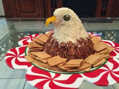 a cake made to look like an eagle sitting on top of a plate with crackers