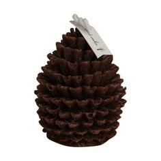 a brown pine cone with a white tag on it