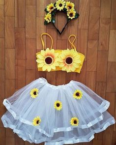 a sunflower dress and headband are hanging on the wall