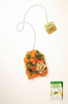 an ornament with flowers and leaves on it next to a packet of tea