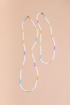 We love our single strand handbeaded necklaces so much that we decided to add a new length! Say hello to Quinn! This necklace is meant for layering, put Quinn with your gold chains, mix her up with another beaded necklace or just wear her solo. Now available in white stripe, vibrant white strand with pops of mint, bubblegum pink, soft purple, and electric blue. - Single strand handbeaded multi colored necklace - Gold filled lobster claw closure - Handmade in Mexico - 23” Fixed length Trendy White Multi-strand Jewelry, Everyday Long Beaded Necklace, Everyday White Single Strand Necklace, White Beaded Necklaces For Layering, Everyday White Single Strand Beaded Necklace, Trendy White Beaded Glasses Chain, Trendy White Festival Beads, White Long Everyday Necklaces, Dainty White Beaded Necklace For Festivals