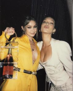 two women in yellow outfits posing for the camera