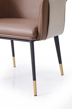 Modrest Calder - Modern Brown & Beige Vegan Leather Dining Chair Bring elegance into your dining space with the Calder Dining Chair! This stylish piece features a contemporary design with modern materials and construction. The combination of two-toned Vegan leather upholstery and black & gold metal legs give the Calder chair a unique and sleek presence while giving it an industrial flare. The Calder pairs well with a solid modern wood dining table or a glass dining table with matching black accents. Features: Upholstered Dining Chair Upholstery: Vegan Leather Color: Brown / Beige Black Metal Legs Gold Leg Caps Belted Layering Feature No Assembly Required Dimensions: Overall: W21.9" x D23.4" x H30.7" Modern Wood Dining Table, Wood Dining Table Modern, Dining Chair Upholstery, Leather Dining Chair, Italian Home, Glass Dining Table, Chair Upholstery, Leather Dining Chairs, Leather Dining