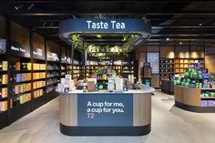 a store filled with lots of different types of teas and drinks on display in front of the counter