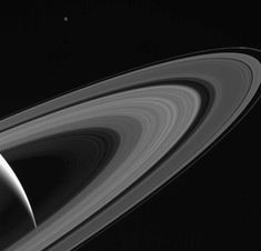 saturn and its rings in black and white, taken by nasa's cassles