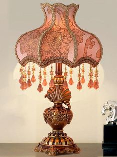 a table lamp with a pink shade on it