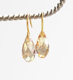 These simple elegant earrings are in the light gold shade of Golden Shadow by Swarovski Crystal. I have attached the sparkling gems to plated ear wires. The briolette measures 13mm for a total length of about an inch. Copyright ©, all rights reserved. LoveYourBling® is an authorized SWAROVSKI® Crystals Branding Partner. Gold Briolette Crystal Earrings For Wedding, Gold Briolette Crystal Earrings With Ear Wire, Gold Briolette Teardrop Earrings For Wedding, Dainty Gold Teardrop Crystal Earrings, Gold Dainty Teardrop Crystal Earrings, Gold Crystal Teardrop Drop Earrings, Gold Crystal Teardrop Earrings, Gold Teardrop Hypoallergenic Crystal Earrings, Gold Hypoallergenic Drop Crystal Earrings