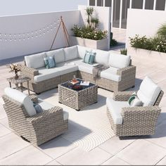 an outdoor patio with wicker furniture and potted plants