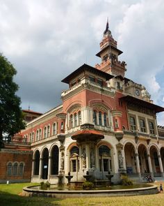 an old building with a fountain in front of it