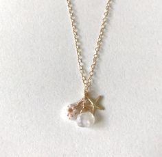 Adorned with a dainty puka shell, rainbow moonstone and a dainty starfish charm, the MAILE necklace evokes the beauty of the ocean.  -  matching earrings available. 1 ready to ship. Ocean-inspired Jewelry With Star Charm, Ocean-inspired Starfish Dangle Jewelry, Ocean-inspired Jewelry With Starfish Charm And Shell Shape, Ocean-inspired Shell Jewelry With Starfish Charm, Delicate Handmade Jewelry For The Beach, Dainty Starfish Necklace For Beach, Bohemian Starfish Charm Necklace For Gift, Starfish-shaped Necklace With Pearl Charm For Gift, Bohemian Charm Necklace With Starfish Charm As Gift