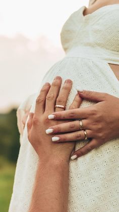 a pregnant woman holding her husband's hand