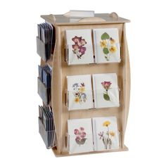 a wooden display case holds several plates and flowers