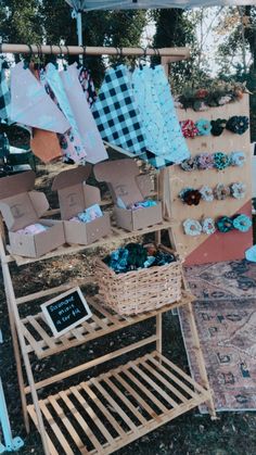 an outdoor market with baskets and clothes on display