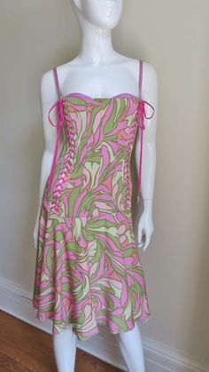 For Sale on 1stDibs - A beautiful fine stretch silk dress in a vibrant pink and green geometric print from Dolce & Gabbana. The bodice is vertically boned and fitted through Pink Dress With Boning For Spring, Fitted Pink Corset Dress For Summer, Spring Pink Corset Dress With Lined Bodice, Summer Pink Corset Back Dress, Pink Spaghetti Strap Dress With Boned Bodice, Pink Summer Dress With Boning, Pink Corset Back Dress For Summer, Green Corset Dress With Spaghetti Straps, Summer Pink Dress With Boning