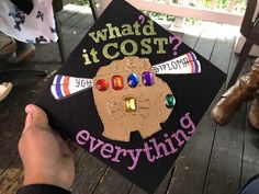 someone is holding up a graduation cap that says, what's it cost?