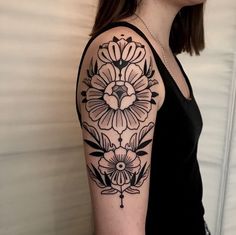 a woman with a black and white flower tattoo on her arm