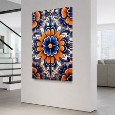 an abstract painting in blue, orange and white with stairs leading up to the second floor