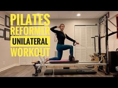 a woman standing on top of a pilates machine in a room with other equipment