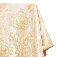 a white and gold table cloth with an intricate design on it's edges, folded in front of a white background