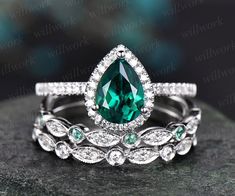 an emerald colored stone surrounded by white diamonds on top of a black rock with the words,