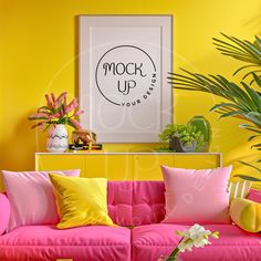 a living room with yellow walls and pink couches in front of a painting on the wall