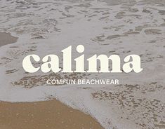 the word calma written in white on top of an ocean beach with waves coming in