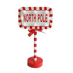 a red and white sign with the word north pole on it's top that says,