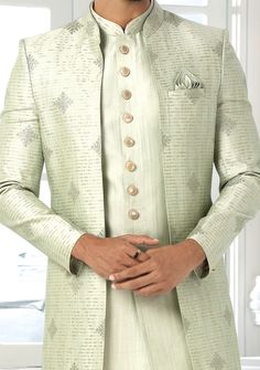 Readymade Art Silk Sherwani, and Jacket. Art Dupion Aligarhi Ready Made Trouser. Resham, Sequences, and Zari Work. Crafted in Chinese Collar Neck, and Full Sleeve. Faux Satin Lining with Plain Work. High-Quality Matching Buttons. Please Note: The footwear shown in the picture is for presentation and photography purpose only. Color: There might be slight color variation due to lightings and flashes while photo shooting. The color may also vary because of different screen resolutions. Wash Care: D Bollywood Style Festive Suits, Fitted Suit With Dupatta In Traditional Drape, Bollywood Style Outerwear With Zari Work For Festive Season, Formal Pista Green Set With Zari Work, Elegant Designer Outerwear For Diwali, Elegant Outerwear With Dupatta For Eid, Fitted Long Outerwear For Festive Season, Semi-stitched Nehru Jacket For Wedding Festivals, Designer Nehru Jacket With Dabka For Festivals