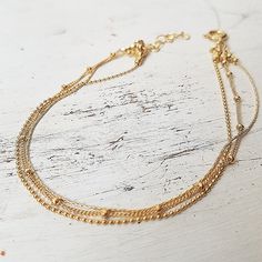 Gold anklet. Summer anklet. Body jewelry. Layered anklet. Minimalist layering gold filled 3 chain ankle bracelet .Very delicate and dainty gold  bracelet  This tiny gold anklet prefect for everyday.Anklet Measures Approximately 8.5"- as default***Please select a size from the options***Made from 14 k gold filled chain.Length - 8.5 inch, 2 inch extension link. Also available in sterling silver.If you would like this chain altered, please convo me.All my jewelry are packed in an elegant gift box.I Adjustable Gold Anklets With Satellite Chain, Gold Anklet With Chain Design For Gift, Dainty Gold Anklet With Delicate Chain, Gold Anklets With Satellite Chain, Delicate Gold Anklet With Adjustable Chain, Gold Anklets With Satellite Chain As Gift, Gold Anklet With Satellite Chain For Gift, Gold Anklets With Tiny Beads As Gift, Delicate Gold Chain Anklets As Gift