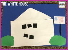 the white house made out of paper with black squares and cut outs on it's side