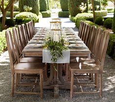 the table is set up with chairs and place settings for people to sit at it