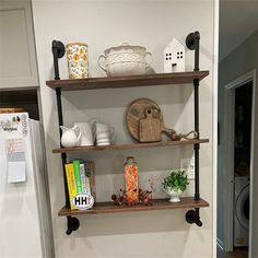 three shelves with various items on them in a kitchen