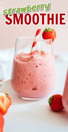 strawberry smoothie in a glass with strawberries next to it on a white table