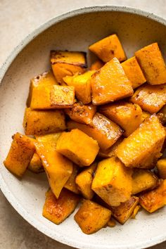 a white bowl filled with cooked sweet potatoes