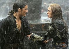 a man and woman standing in the rain