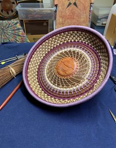 a purple bowl sitting on top of a blue table