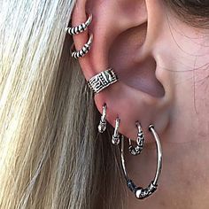 a woman with ear piercings that says, look no further for the look you want