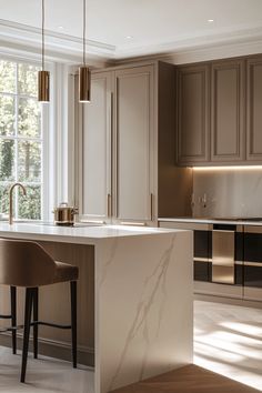 a kitchen with an island and two bar stools in front of the countertop